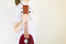 a girl holding a musical instrument 