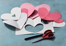 construction paper, scissors, and marker to make homemade Valentine's day cards