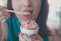 woman eating a cup of ice cream 