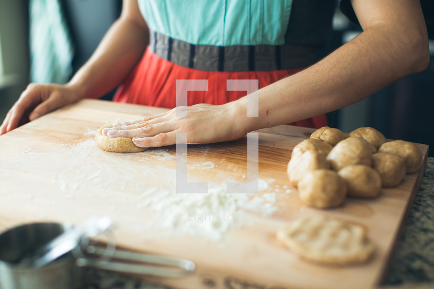 a woman in the kitchen baking cookies 