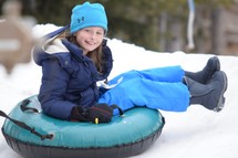 a girl tubing in the snow 