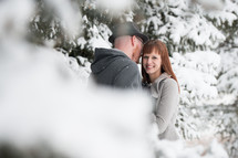 a couple kissing in the snow 