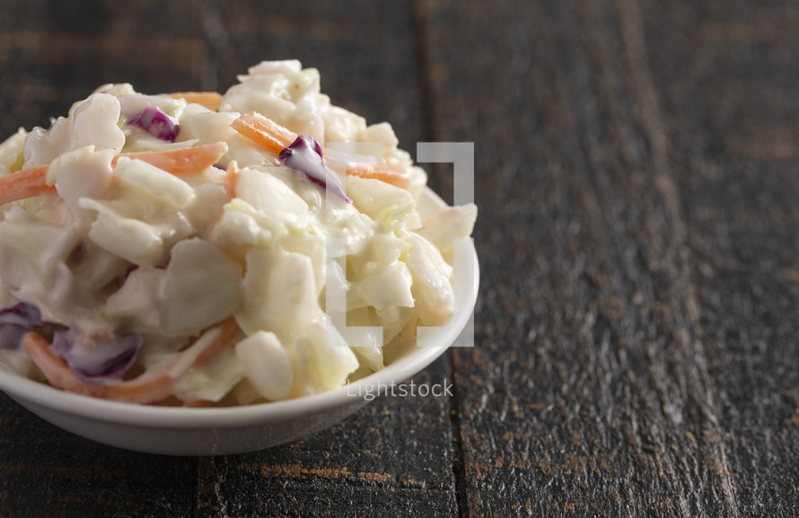 Bowl of Traditional Coleslaw on a Rustic Wooden Table