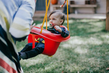 a toddler girl on a swing 