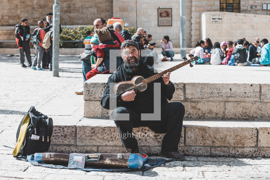 man playing music on the streets of Jerusalem 