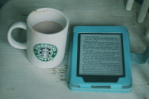 Starbucks coffee mug and Bible app on a tablet 