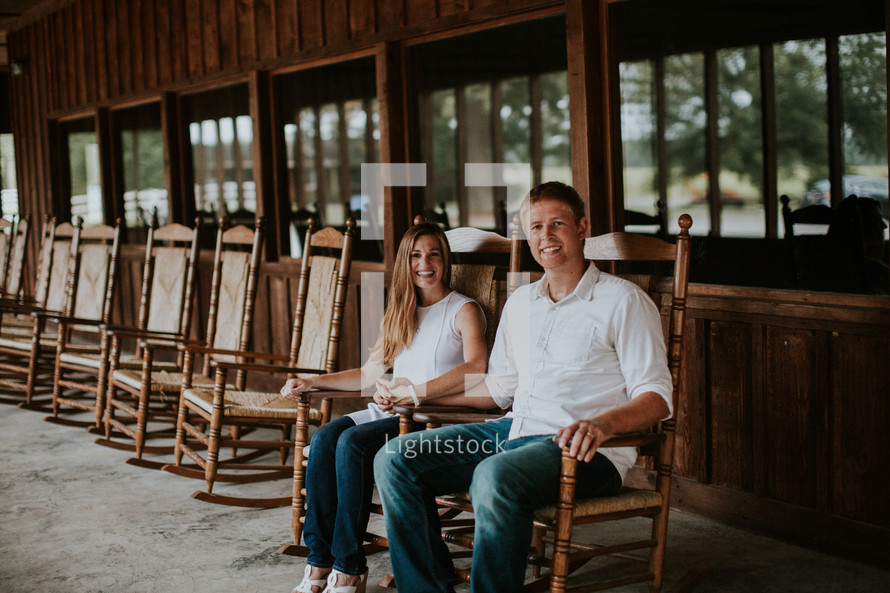 couple sitting in rocking chairs 