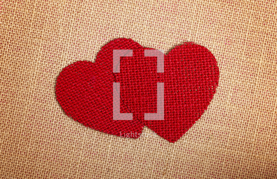 Red Burlap Hearts on a brown burlap Background