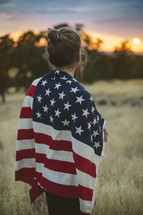 a woman with an American flag around her shoulders 