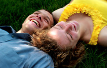 young couple lying in the grass 