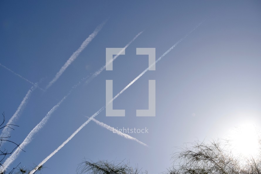 plane contrails in a sky at sunset 