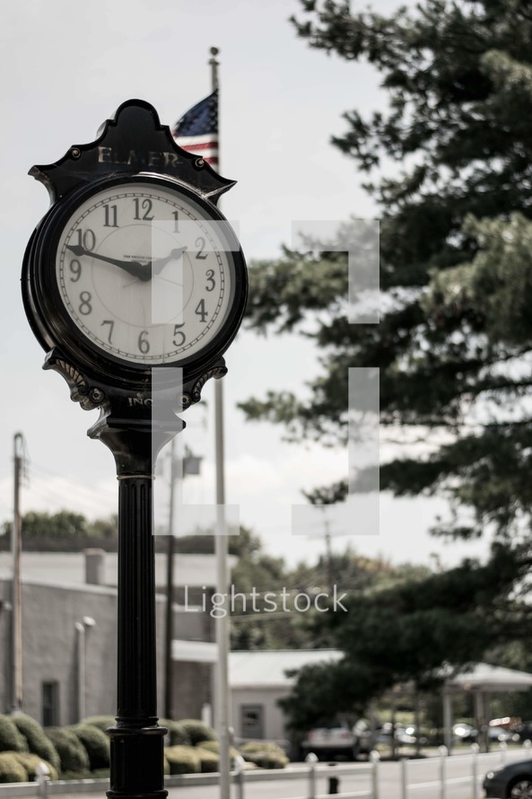 clock on a downtown sidewalk 