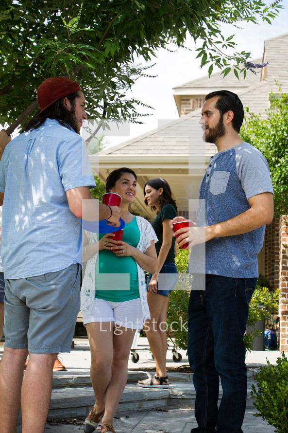 friends talking at an outdoor gathering 