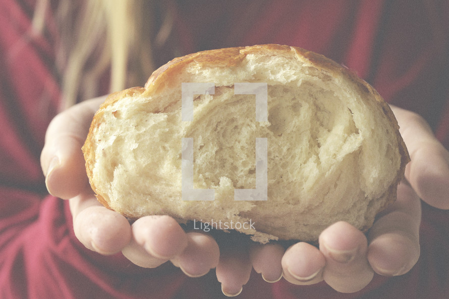 cupped hands holding bread 