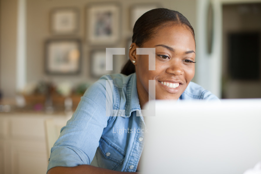 African American woman looking at a computer screen 