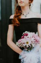 teen girl holding a bouquet for prom
