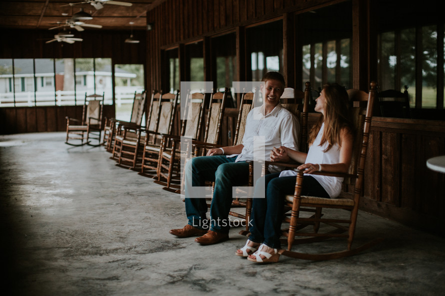 couple sitting in rocking chairs 