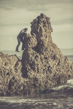 A man climbing a rock formation.
