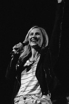 woman on stage with a microphone 