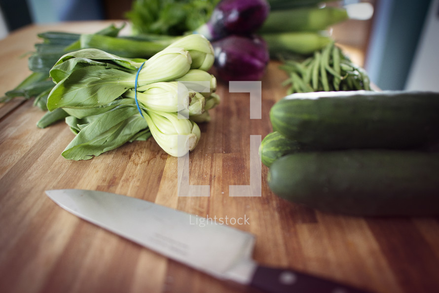 vegetables and knife on a cutter board 