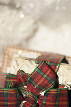 Red and green bows on wrapped gifts