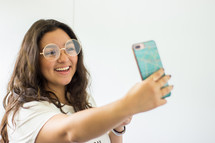 a teen girl taking a selfie 