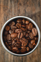Closeup of roasted coffee beans in coffee machine filter