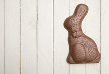 chocolate bunny on a white wood background 