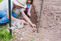 grandfather and granddaughter gardening 