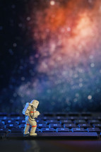 Conceptual astronaut on space. Sitting on space key