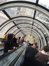 people riding an escalator 