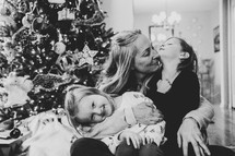 Grandmother with girls in front of Christmas tree