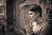 a teen boy with praying hands 