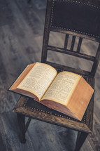 an open book on a chair 