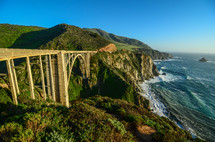 a bridge over a ravine along a shore over cliffs 