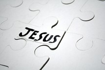 word Jesus on a puzzle piece 