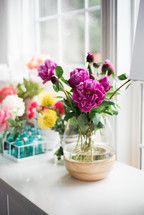 flowers in a vase in a window sill 