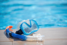 Scuba diving mask near swimming pool on vacation at resort
