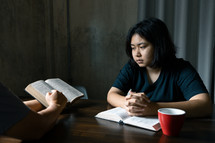Asian family studying the Bible together