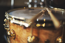 a close up of snare drum and sticks (color version)