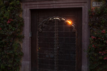 light peeking through the crack of a metal gate 