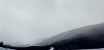 fog over a snowy mountain