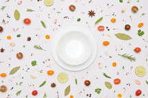 Colorful Spices for and Herbs for Cooking pattern on white with bowl 