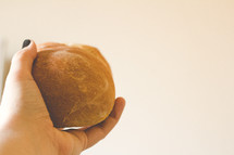 hand offering bread