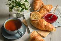 Closeup Table with Fresh baked croissant and tea