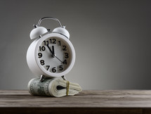 alarm clock and roll of cash 