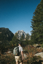 a man hiking on a mountain path 
