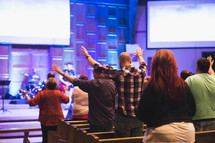 congregation with raised hands in worship 