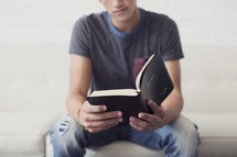 a young man reading a Bible 