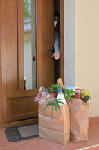 groceries in front of a front door 
